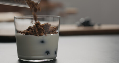 making granola with blueberries in glass with copy space
