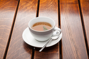 Cup of green tea on wooden table, evening relaxation