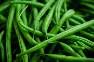 Close up green beans on a black background with soft light