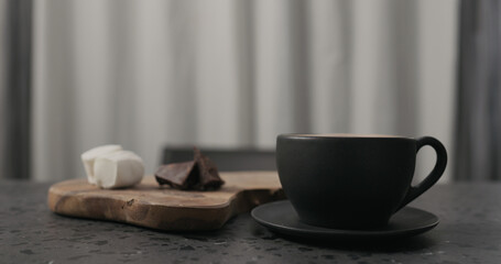 cup with hot chocolate on concrete countertop