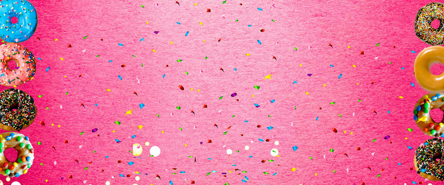 colorful donut with sprinkle on pink background. Background image with copy space
