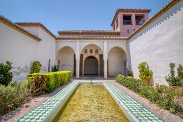 Fototapeta premium Moorish style architecture in the Alcazaba of Malaga, a palatial fortification from the Islamic period whith beautiful gardens, in Malaga, Costa del Sol, Andalusia, Spain.
