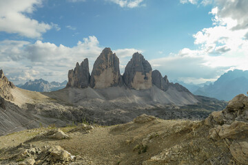 A panoramic capture of the famous Tre Cime di Lavaredo (Drei Zinnen) and surrounding mountains in Italian Dolomites. The mountains are surrounded by thick clouds. A lot of landslides. Serenity