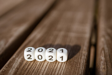 cubes are white with numbers that make up the year 2021