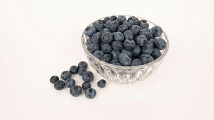 Ripe blueberries in glass dish.