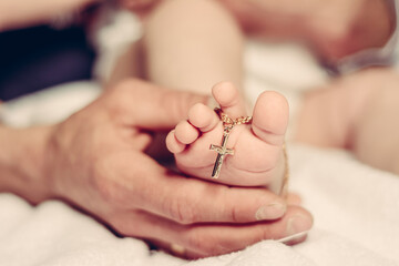 Baptism of a baby, close up of tiny baby feet, sacrament of baptism.