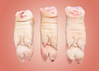 Pork hoof feet isolated on pink background.