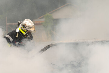 Firefighter intervening in a car fire