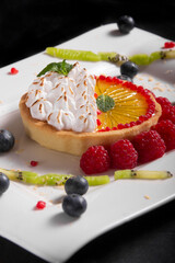 Lemon pie with sugared cream and berries