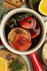 Spicy mulled wine with ingredients around. Pot of mulled wine, traditional christmas drink.