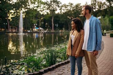 Fototapeta premium Romantic love couple walking at the pond in park
