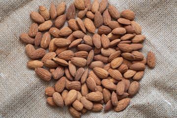 Roasted almonds on an insulated table. varieties of almonds grown in Turkey is more. There are various types of almonds such as roasted, candied, chocolate.
