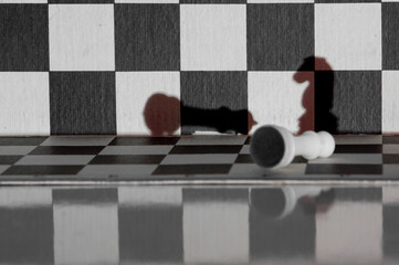 Chess knignt shadow checkmates white king