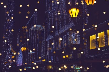 Christmas lights and decoration in the city in Winter. Colorful abstract image created by multiexposure.