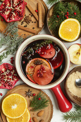 Spicy mulled wine with ingredients around. Pot of mulled wine, traditional christmas drink.