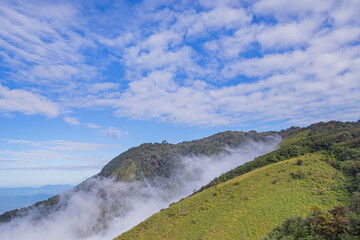 Beautiful scenic view of mountains and clouds against the sky in Kew Mae Pan nature trail at Doi Inthanon, Chiang Mai, Thailand. Famous tourist attractions of Thailand. Concept of holiday and travel