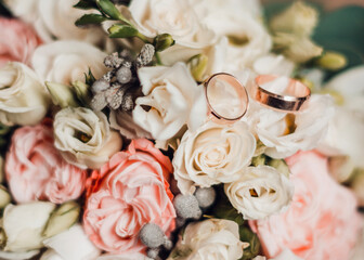 Delicate bouquet for the bride and engagement rings, photo close up.