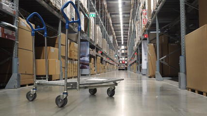 Inside warehouse with cart and high shelves . No people and Bottom view.