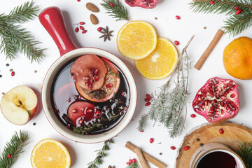 Spicy mulled wine with ingredients around. Pot of mulled wine, traditional christmas drink.