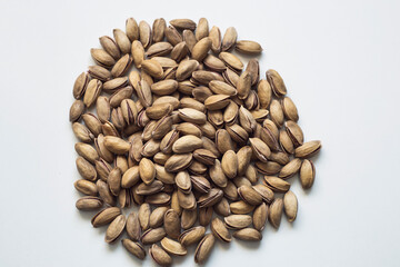 Nuts on an insulated white table. Pistachio. It grows in Turkey. It is a special product. ( Antep fıstıgı)