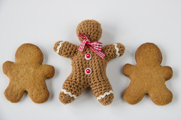 close up of gingerbread man crocheted and two biscuits