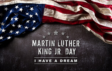 Happy Martin Luther King Day concept.  American flag againt dark stone background - obrazy, fototapety, plakaty