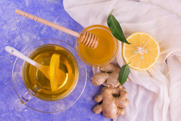 Ginger tea with lemon on a blue background. Top view.