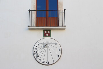 Old solar clock on the wall of the house, Monopoli, Italy
