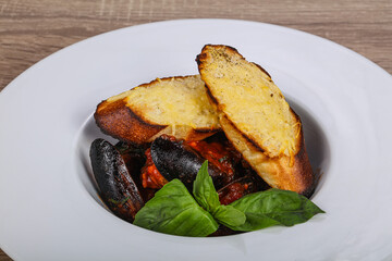 Mussels in the bowl with bread