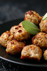 Pork stuffing meatballs with sage and onion in a black plate