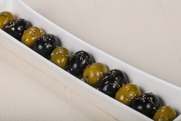 Black and green olives in the bowl