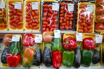 Sets of vegetables packed in plastic package in supermarket. Tomato, red and green pepper. Mendoza,...