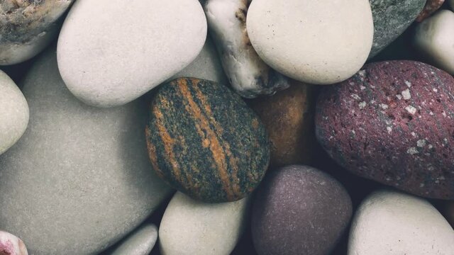 Rotating pebbles background. View from above.