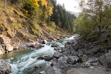 Naklejka na ściany i meble Rough mountain river. Clear clean river in the highlands. Autumn landscape