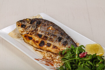 Grilled dorada fish served lemon