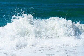 Stormy sea on a sunny day. Wave with white foam on the crest. Beautiful nature