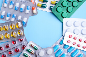 Circle of pills and capsules of various shapes and colors. Healthcare, treatment, medicine concept.