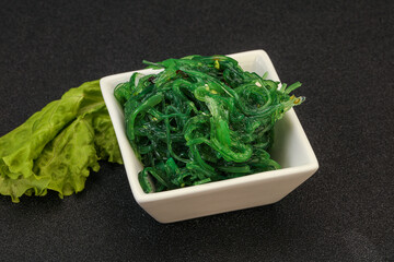 Green Chuka Seaweed Salad Isolated on White Background Top View. Wakame Sea Kelp Salat