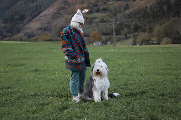 Woman playing with her dog in the field