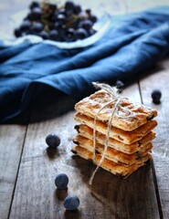 Delicious biscuits with raisins on a wooden background