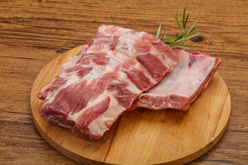 Raw pork ribs served rosemary