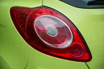 Close-up view of green car's stylish taillight