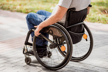 Obraz premium Handicapped man in wheelchair walk at the park alley