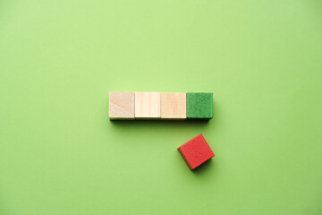A wooden cube on green backgroud, business, finance and education concept