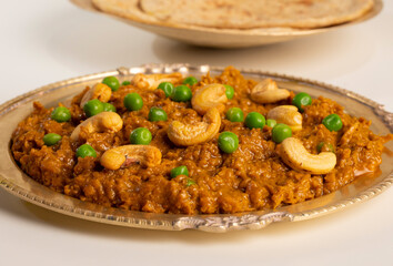 Rajasthani Famous Traditional Cuisine Haldi Sabji or Tukkar Served with Salad on White Background