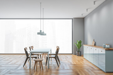 Grey and wooden dining room with window, wooden furniture on parquet