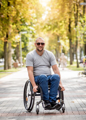 Fototapeta premium Handicapped man in wheelchair walk at the park alley