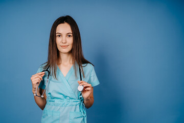 beautiful successful female doctor with stethoscope isolated on blue