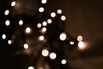 Christmas background. Shiny bokeh on a dark background.