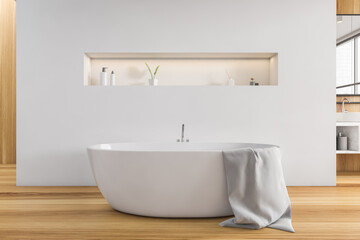 Naklejka na ściany i meble Wooden and white bathroom with white bathtub on wooden floor, deck for gels